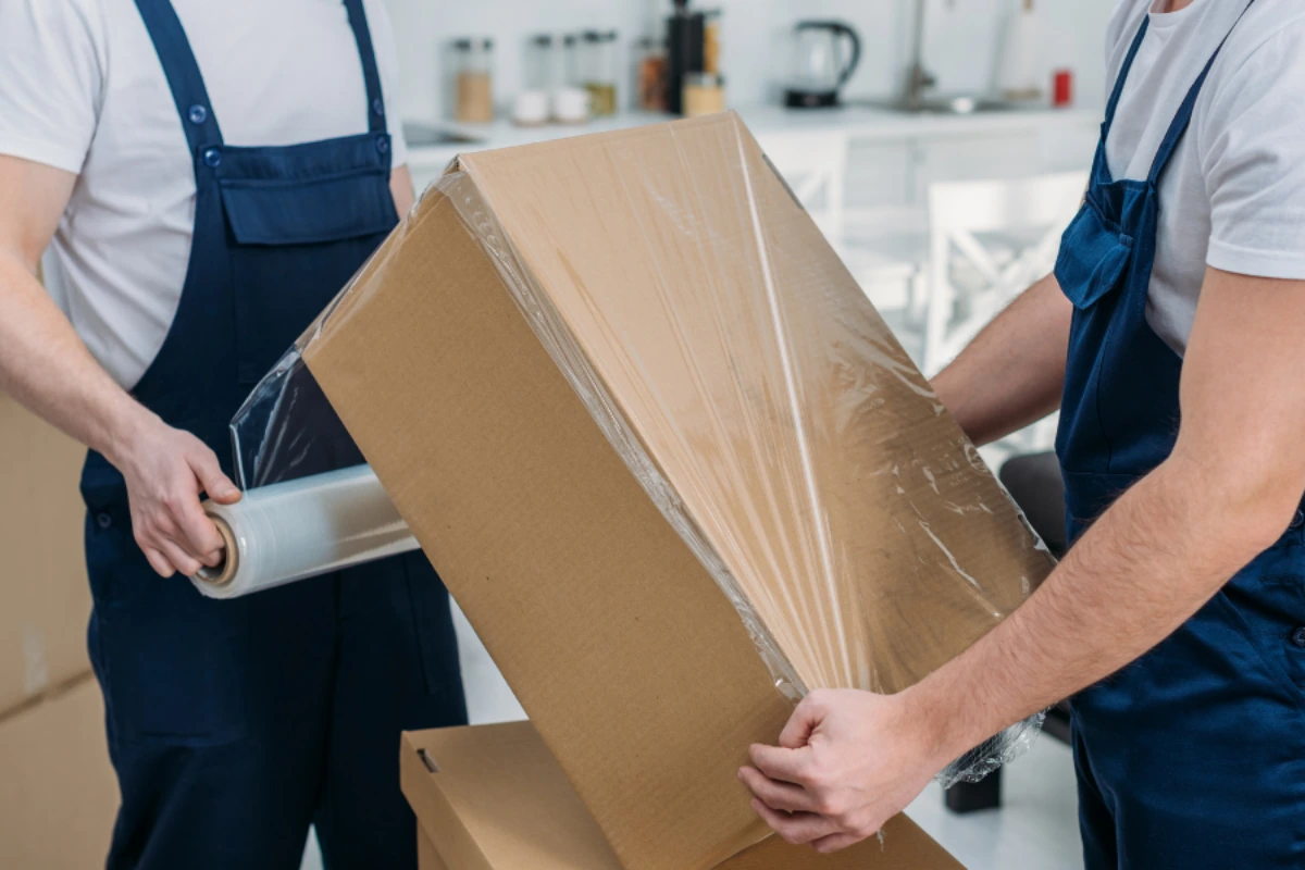 Movers packing apartment furniture and personal belongings for secure relocation in Dubai