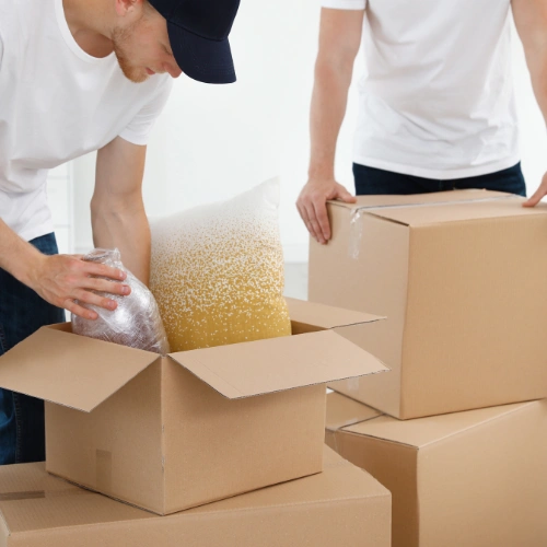 Experienced villa movers carefully handling fragile and high value household items