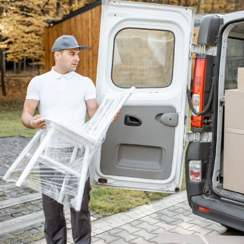 Professional movers loading townhouse furniture and boxes into a moving truck