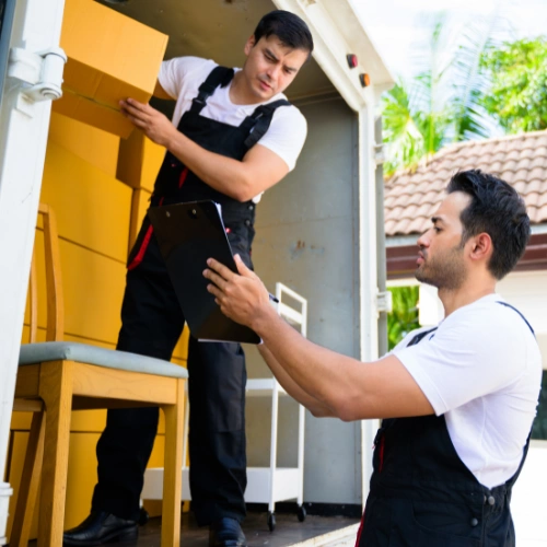 Professional movers loading premium villa furniture into a moving truck in Dubai