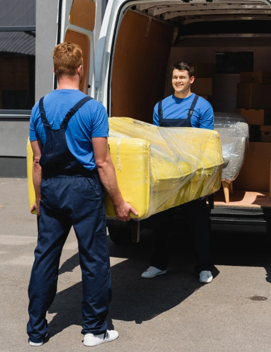 Professional movers loading premium villa furniture into a moving truck in Dubai